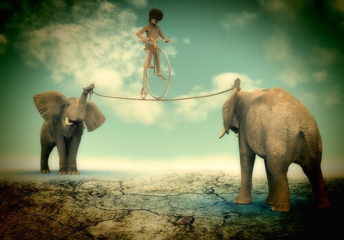Niño en equilibrio sobre una cuerda sostenida por dos elefantes en su extremo
