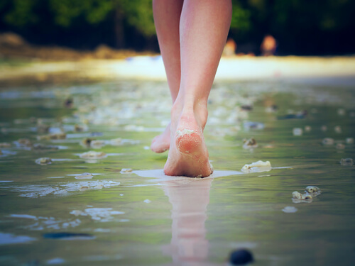 Mujer caminando sobre playa