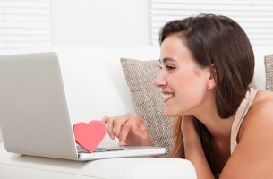 Mujer con un corazón en el ordenador hablando por internet