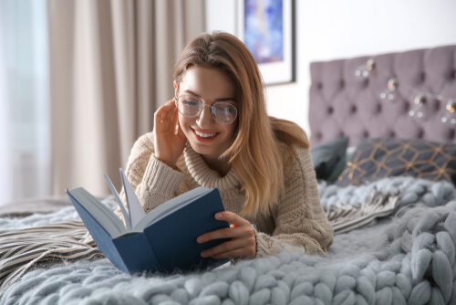 Woman reading book in her room