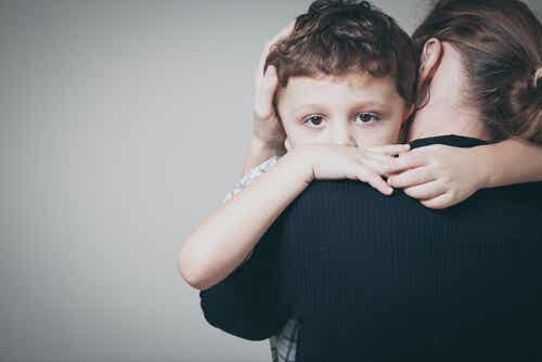 Niño traumatizado abrazando a su madre