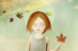 Chica triste con una hoja de un árbol en la mano