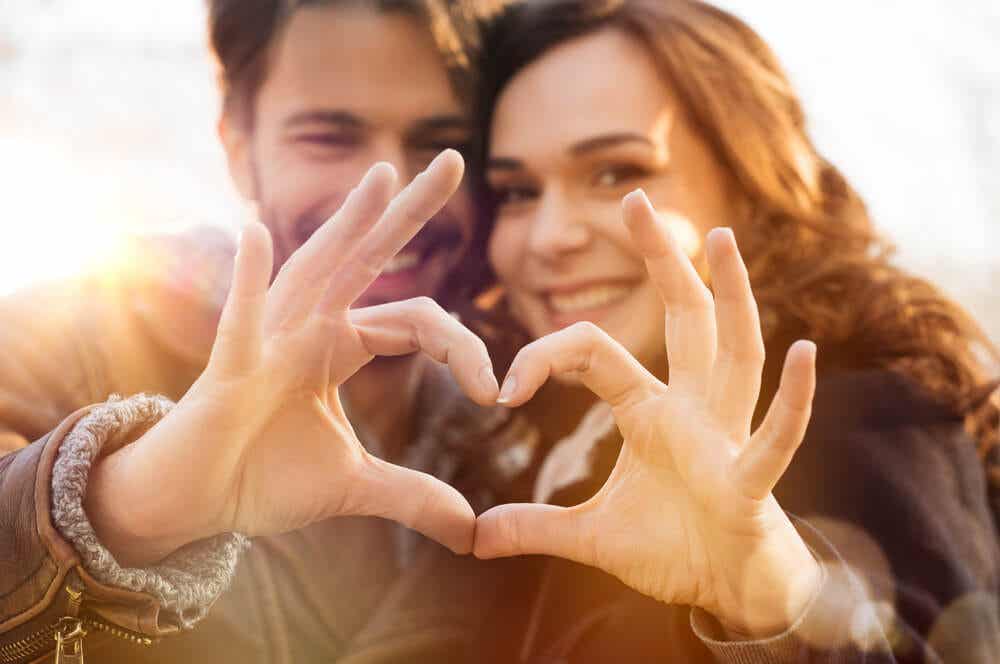 Couple forming heart with their hands