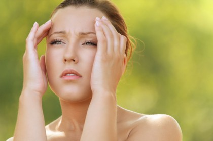 young woman holding head in pain