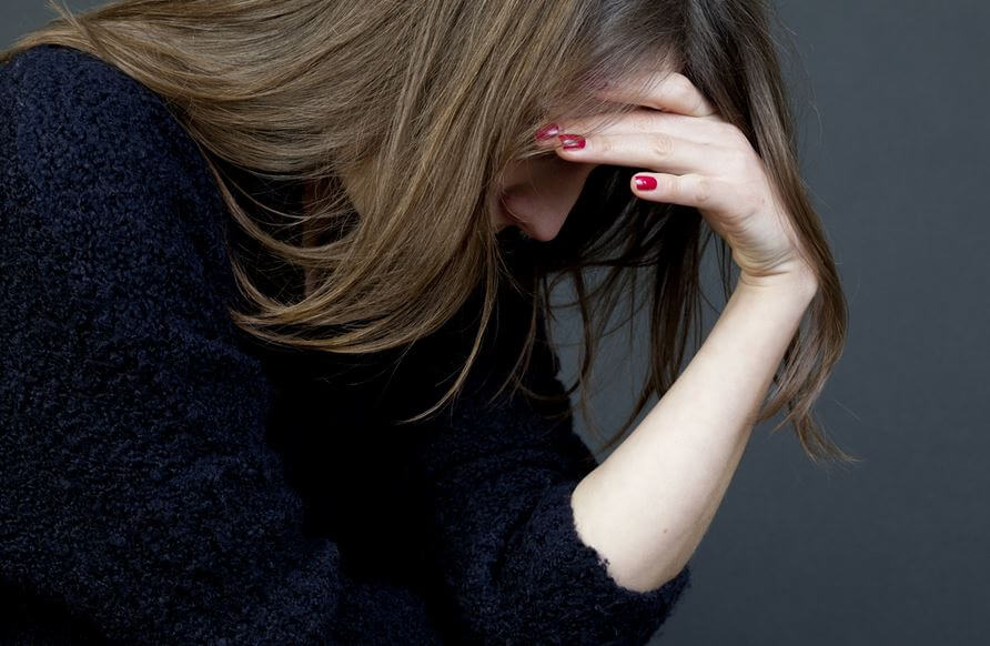 woman with head in hand