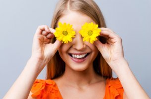 Mujer con dos flores en los ojos y pensamientos positivos