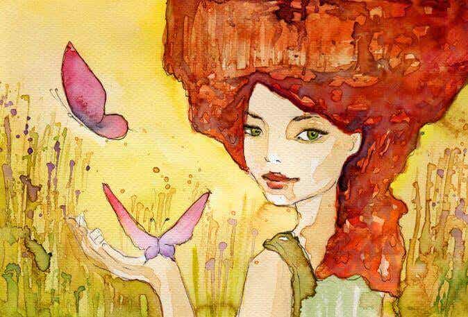 Mujer con el pelo rojo con mariposas en la mano