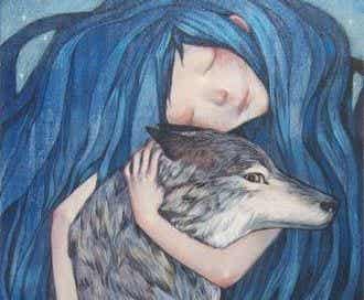 Chica con el pelo azul abrazando a un lobo
