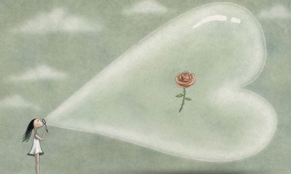 niña soplando un corazón