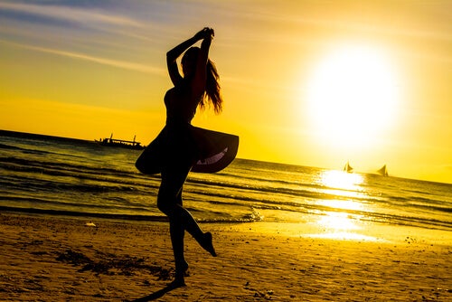 Nainen tanssimassa rannalla