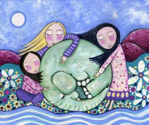 Girls hugging an elephant