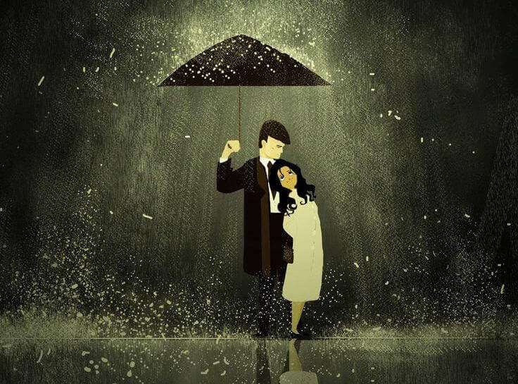 Pareja con un paraguas bajo la lluvia y enfocada por una luz