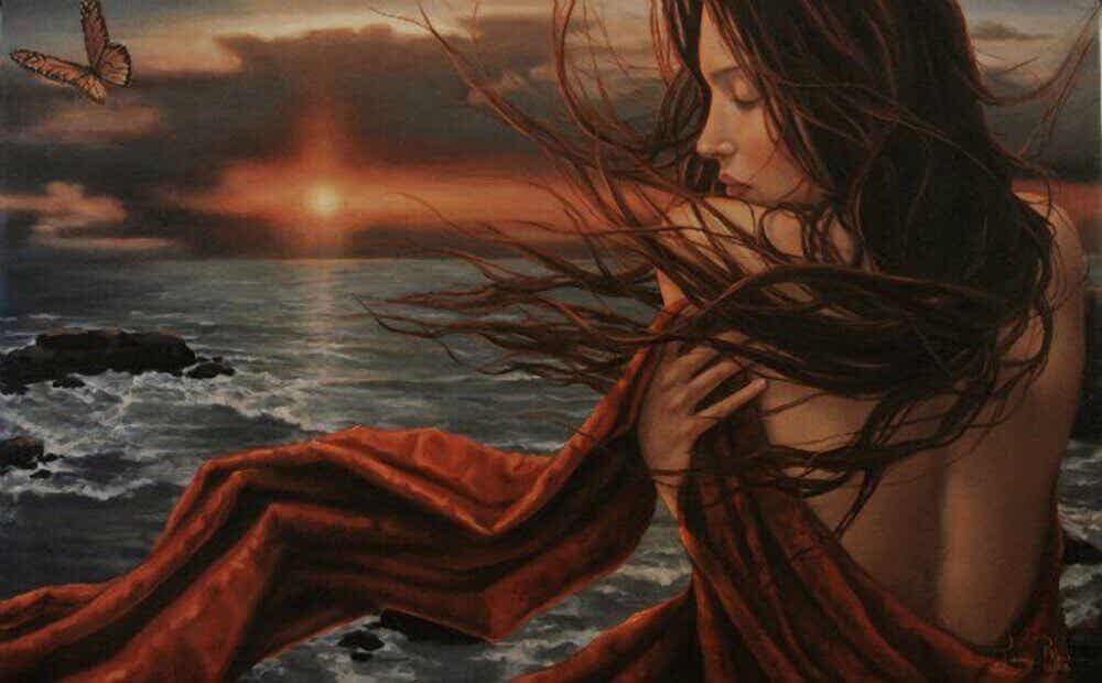 Mujer abrazándose frente al mar