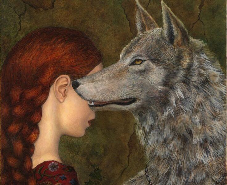 Joven con lobo que muestra coraje