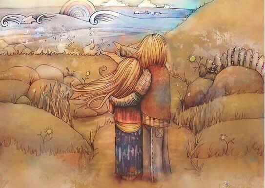 Pareja abrazada viendo el arco iris