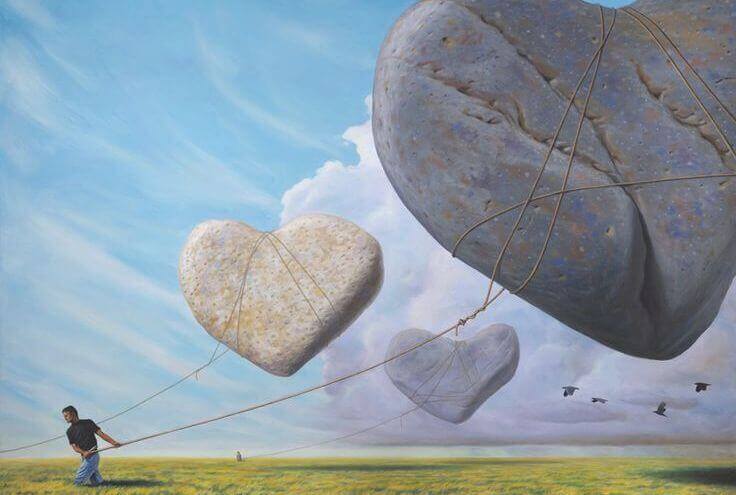 Hombre arrastrando corazones de piedra que simbolizan discusiones de pareja