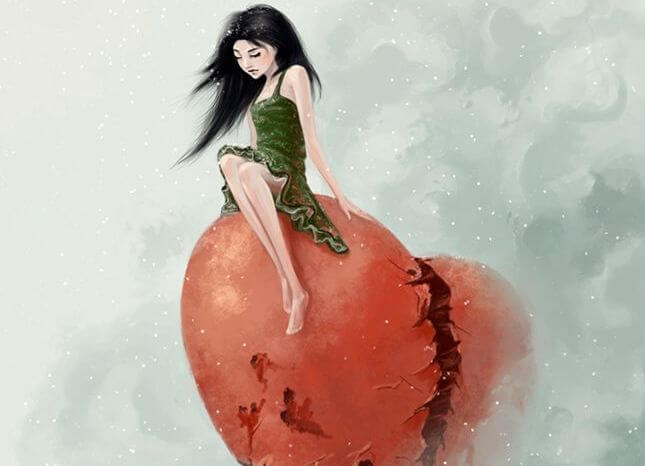 Mujer sentada en un corazón roto