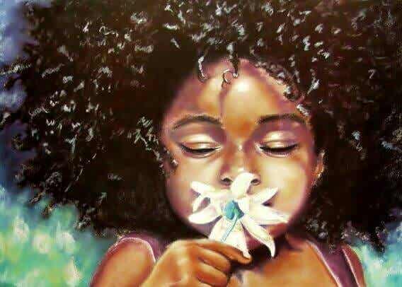 colored girl smelling a flower