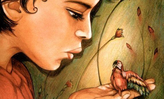 niño con un loro en la mano