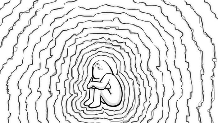 Hombre sentado sufriendo por amor con muros a su alrededor