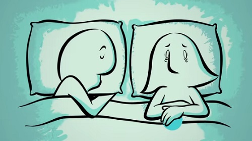 Mujer despierta en la cama con su marido durmiendo