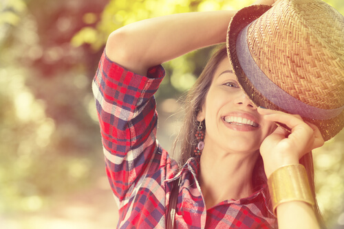 Mujer sonriendo con un sombrero en la cabeza