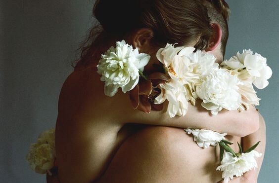 couple embracing with flowers