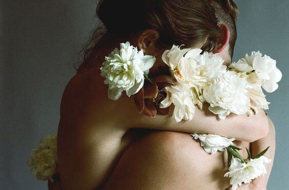 couple embracing with flowers