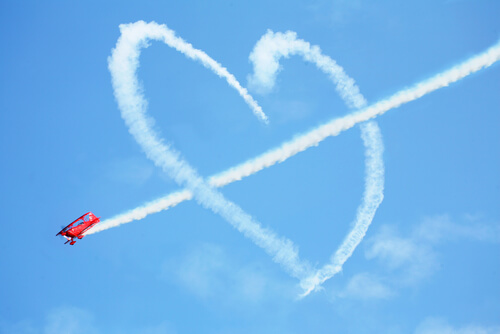 Corazón de nubes atravesado por un avión