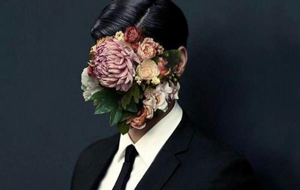 Ilustração de um homem com flores no rosto.