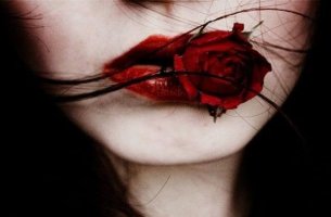 mujer con rosa roja en la boca