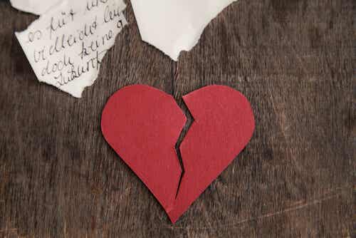 Broken heart on a wooden table symbolizing when an ex rebuilds his life