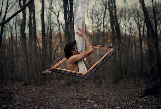 man hanging from tree