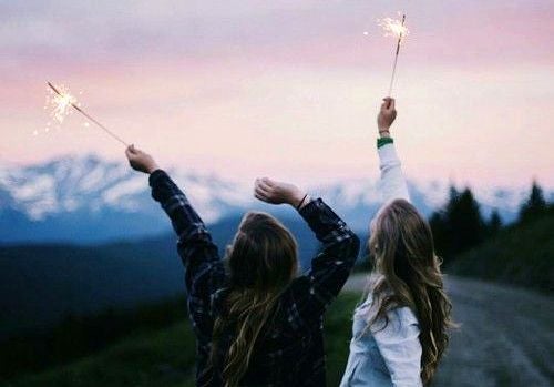 friends holding sparklers