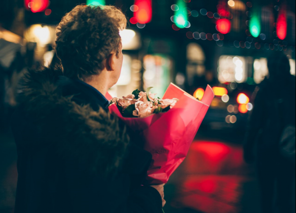 man holding flowers
