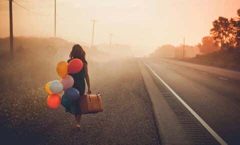 woman carrying balloons