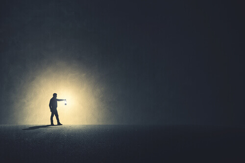 Hombre con luz en la oscuridad