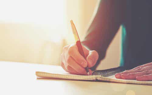 Hombe escribiendo un diario tras una ruptura de pareja