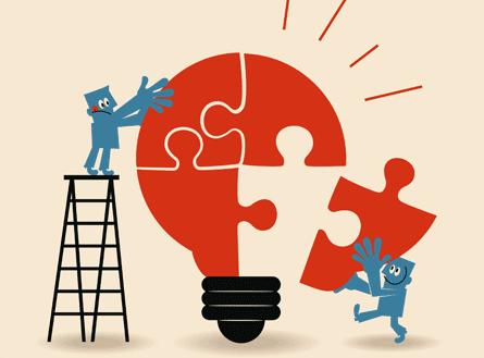 Personas formando el puzzle de una bombilla