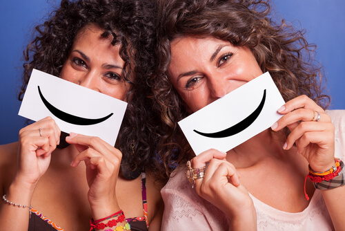 Friends holding a sign with a smile