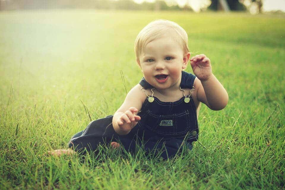 baby playing in a field