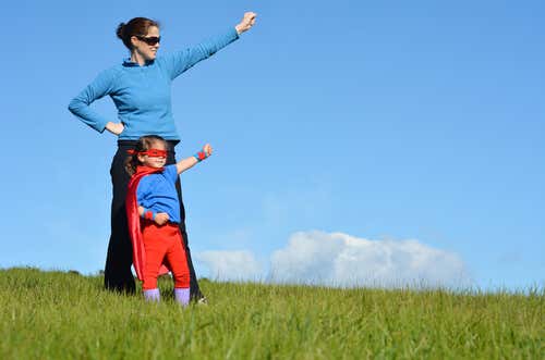 mother with mask and her daughter dressed as a superhero