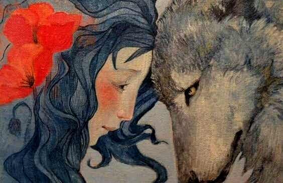 mujer apoyando su cabeza frente a un lobo