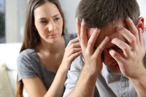 Mujer consolando a un hombre con dolor