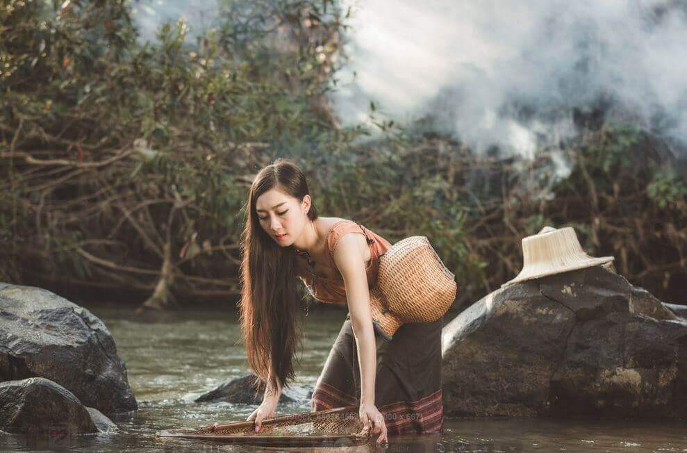 woman in lake thinking about gray clouds