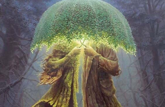 pareja escondida bajo un paraguas de hojas