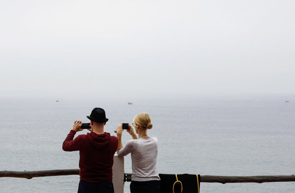 Pareja con móvil haciendo fotos