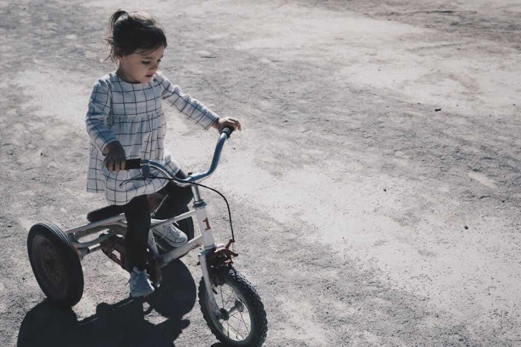 girl riding tricycle helps avoid childhood obesity