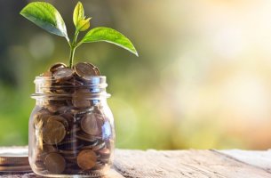frasco con dinero con el que mejorar la situación económica