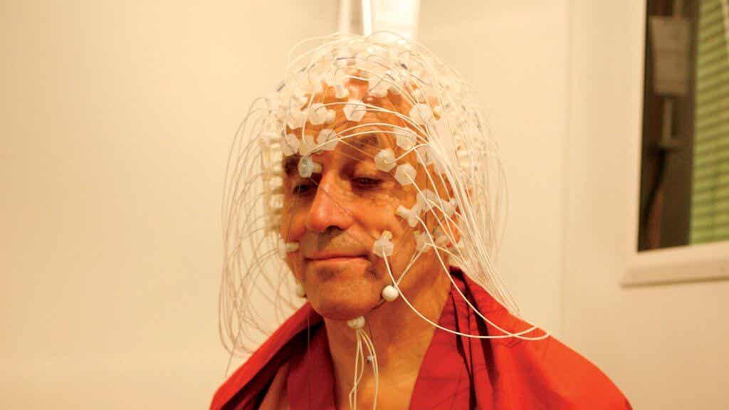 Matthieu Ricard, the happiest man in the world, with electrodes on his head